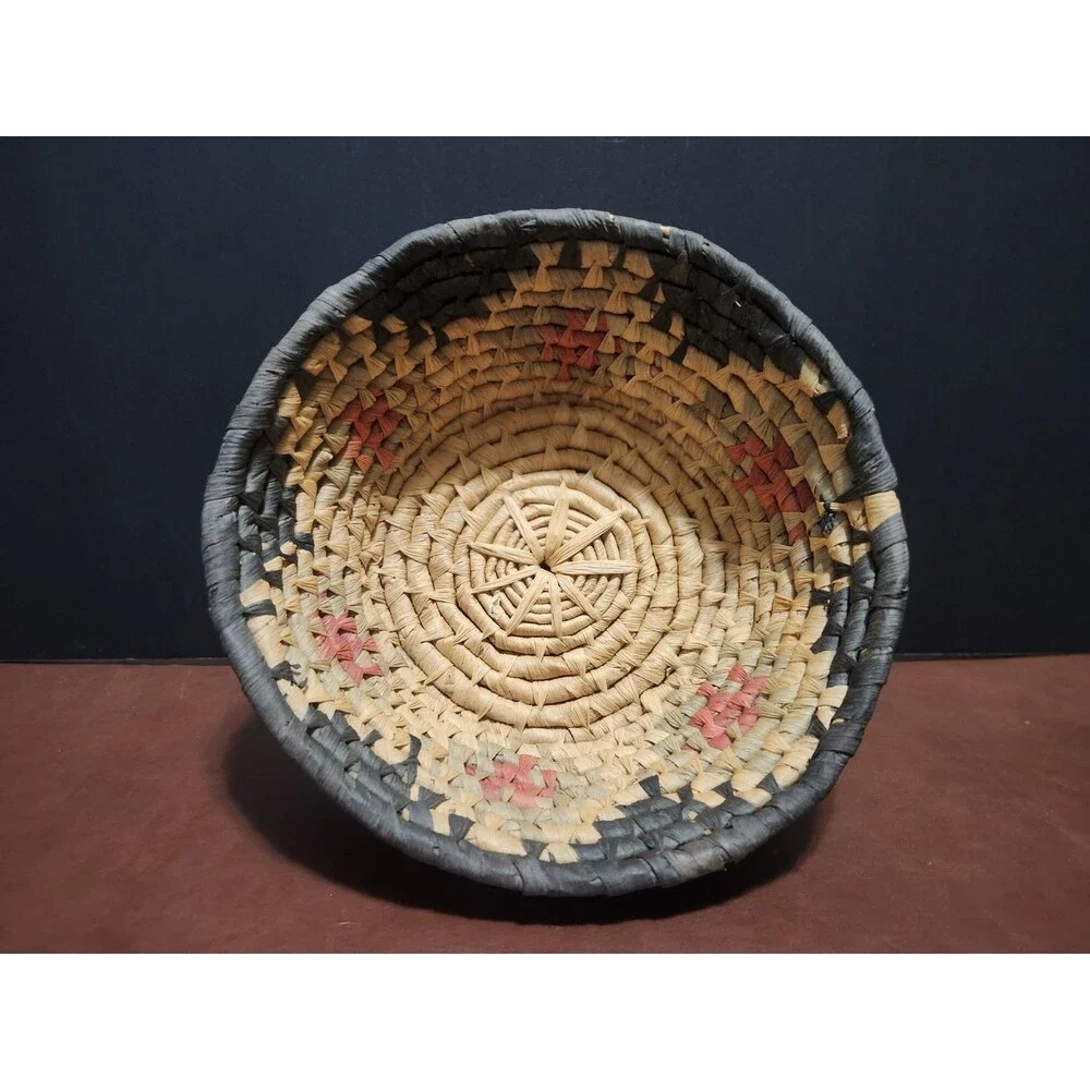 This handmade, round basket resembles those traditionally crafted by artisans.